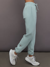 Model is wearing Sportswear Regular Sweatpant in Vapour Green, side view.