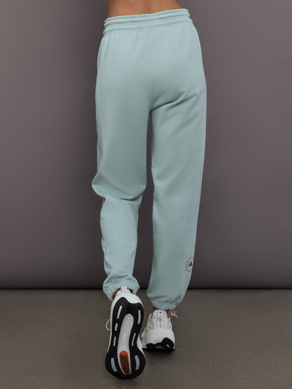 Model is wearing Sportswear Regular Sweatpant in Vapour Green, back view.