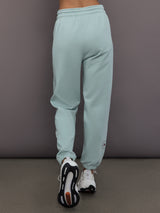 Model is wearing Sportswear Regular Sweatpant in Vapour Green, back view.