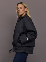 Model is wearing Liner Water-Resistant Jacket in black, side view with pocket detail.