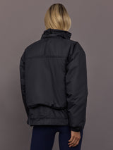 Model is wearing Liner Water-Resistant Jacket in black, back view.