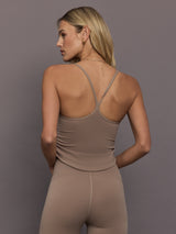 Model is wearing adidas by Stella McCartney Studio Spaghetti Crop Top in Chalky Brown, back strap detail.