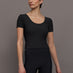 Model wears a cropped black scoopneck short sleeve top.