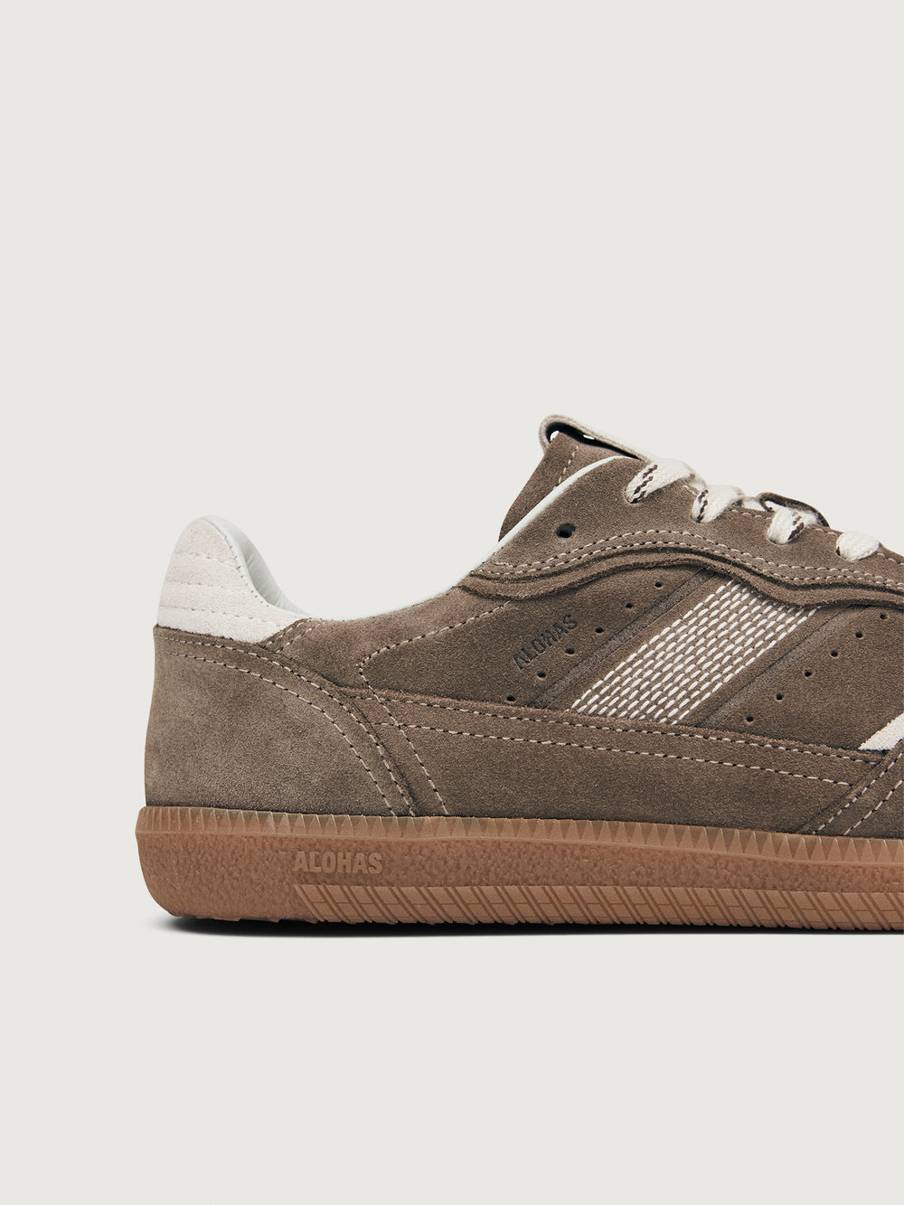 Brown sneaker with white accents.