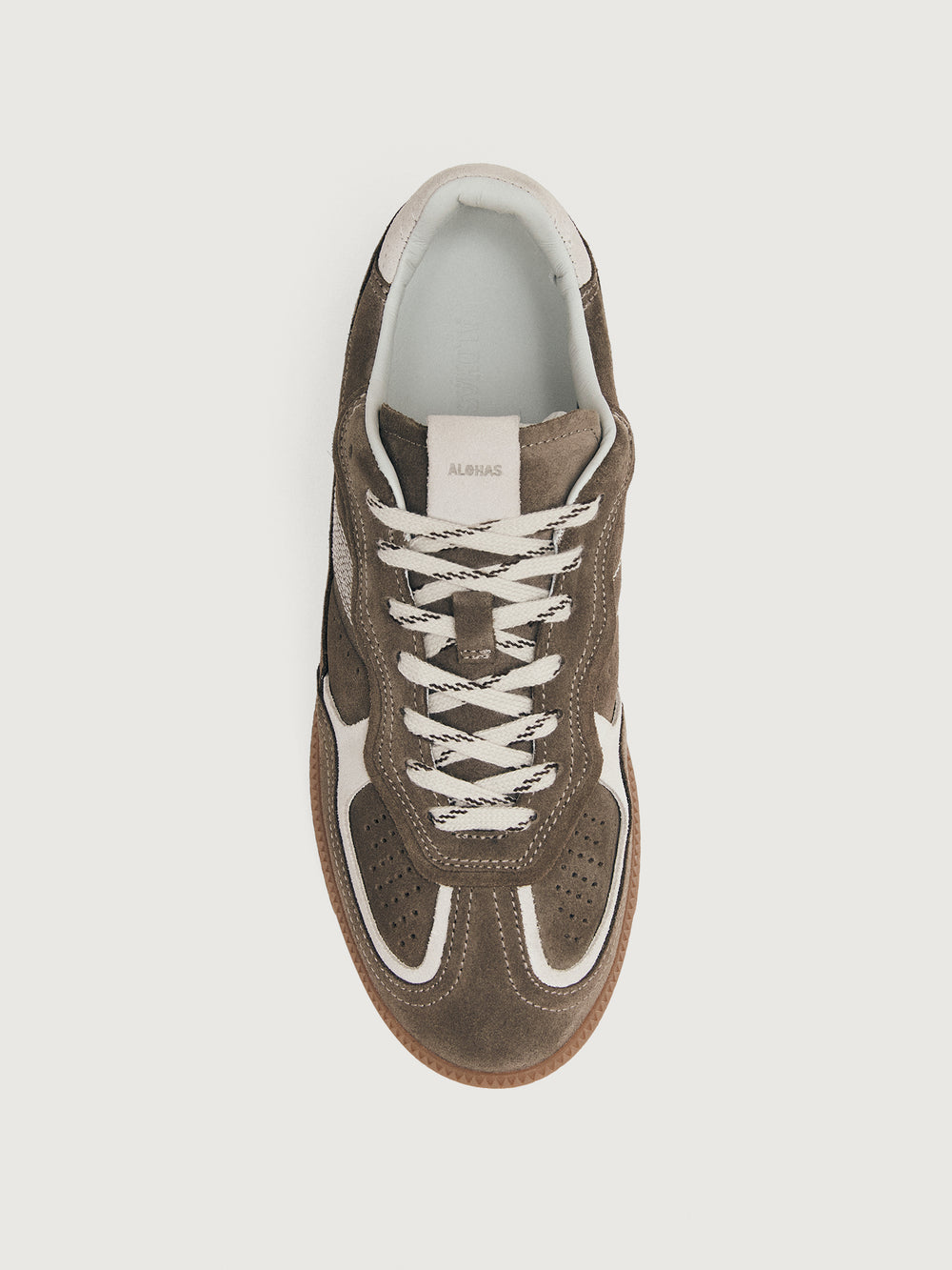 Brown sneaker with white accents.