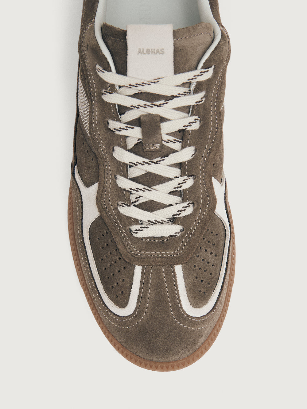 Brown sneaker with white accents.