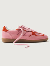 Pink clay colored suede low top lifestyle sneaker with red detailing. 