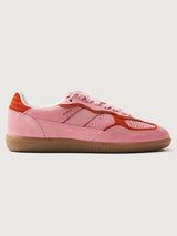 Pink clay colored suede low top lifestyle sneaker with red detailing. 