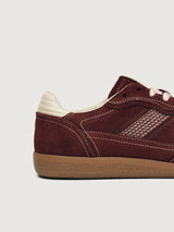 Burgundy sneakers with beige accents.