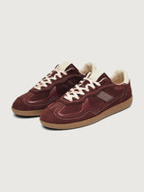Burgundy sneakers with beige accents.