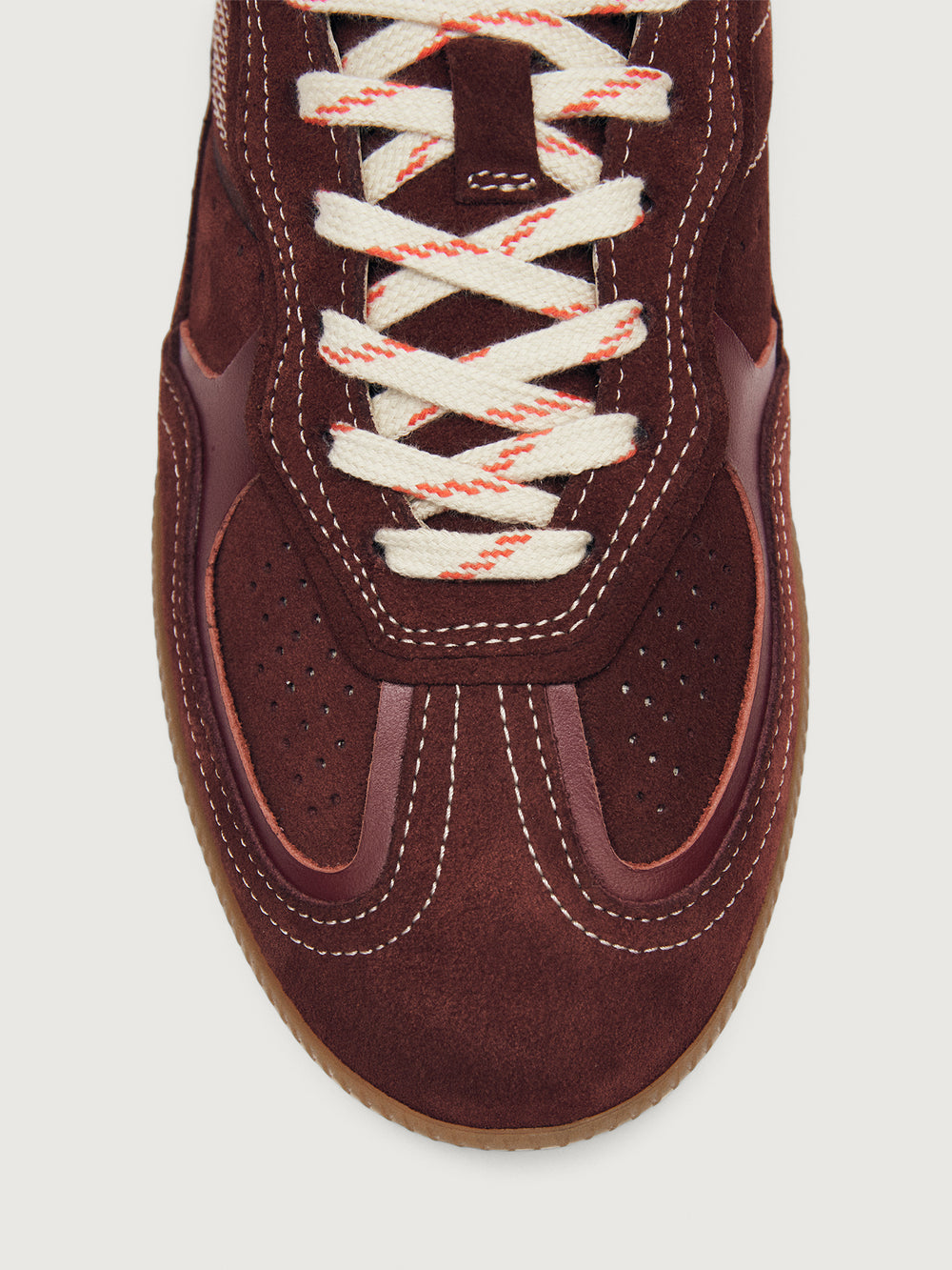 Burgundy sneakers with beige accents.