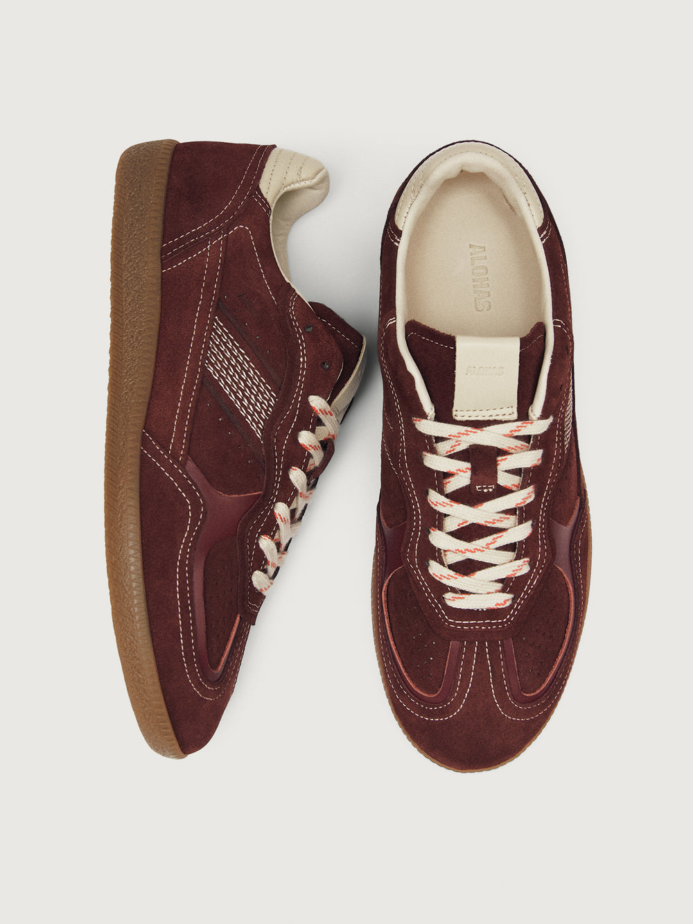 Burgundy sneakers with beige accents.