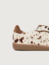 Cowhair creme colored shoe with brown cow print and suede brown heel detailing. 