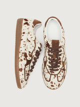 Cowhair creme colored shoe with brown cow print and suede brown heel detailing. 