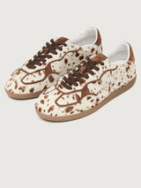 Cowhair creme colored shoe with brown cow print and suede brown heel detailing. 