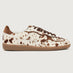Cowhair creme colored shoe with brown cow print and suede brown heel detailing. 