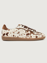 Cowhair creme colored shoe with brown cow print and suede brown heel detailing. 