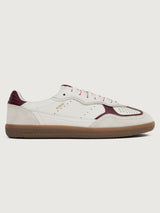 White sneaker with maroon accents.