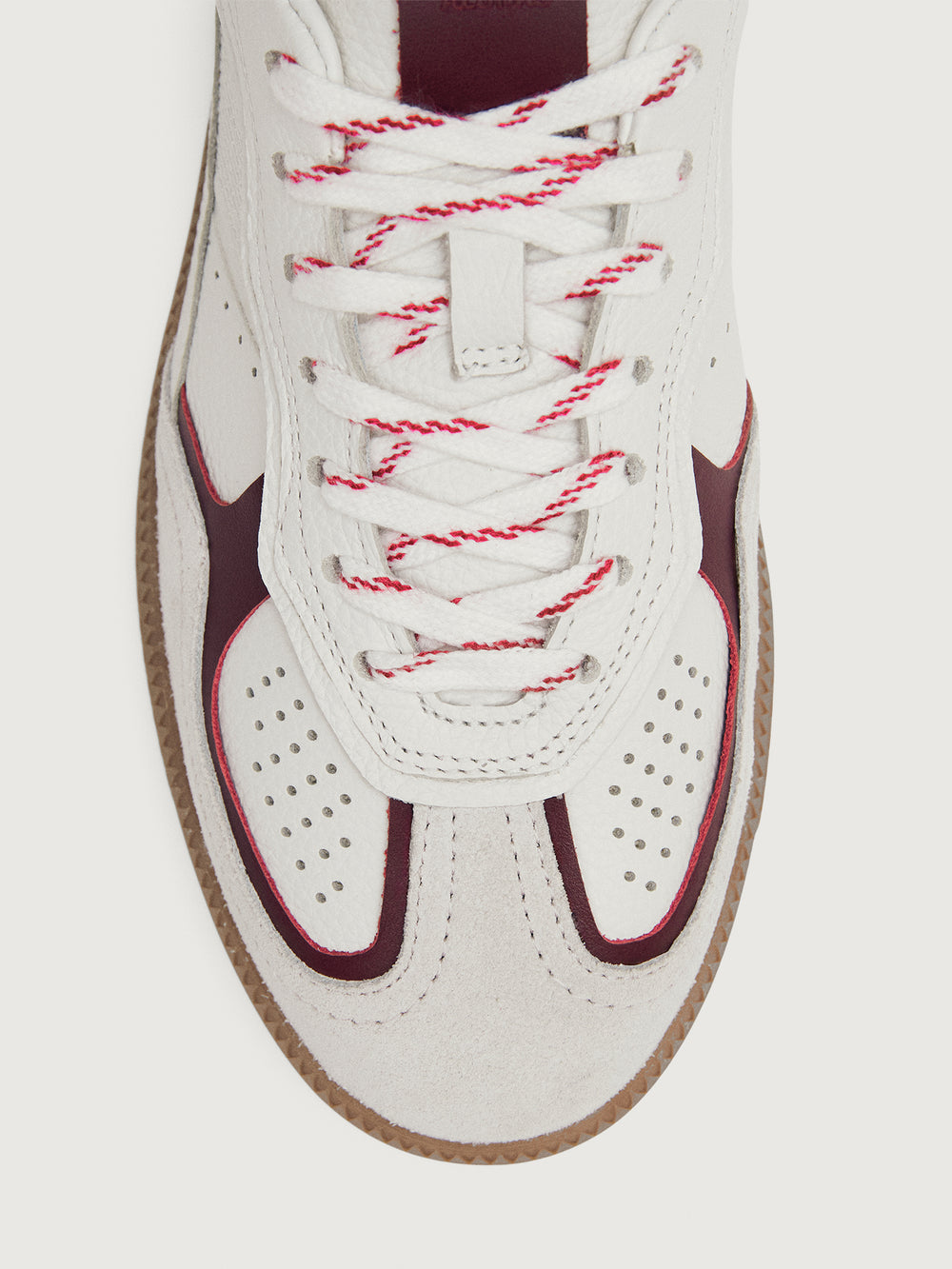 White sneaker with maroon accents.