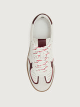 White sneaker with maroon accents.