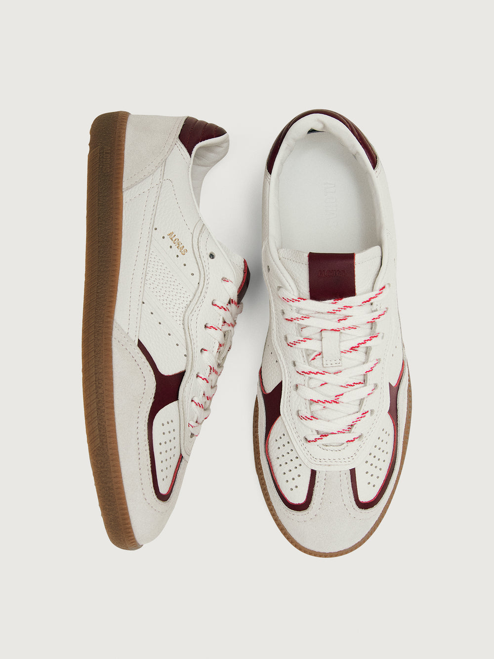 White sneaker with maroon accents.