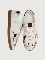 White sneaker with maroon accents.