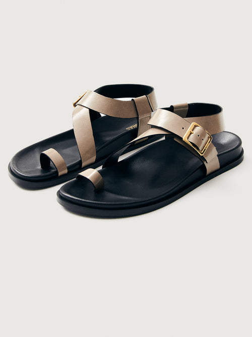 Taupe suede sandal with black sole and gold hardware. 