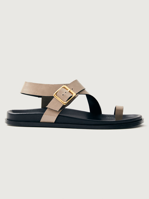 Taupe suede sandal with black sole and gold hardware. 