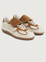 Neutral cowhair low top sneaker with chestnut tongue, sole, and heel. 