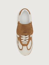 Neutral cowhair low top sneaker with chestnut tongue, sole, and heel. 