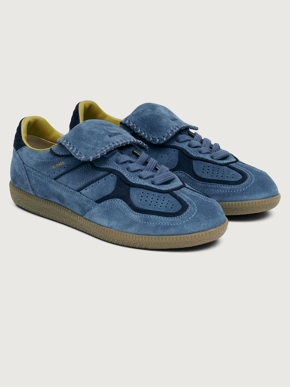 Denim blue suede low top lifestyle sneaker with navy heel detailing. 