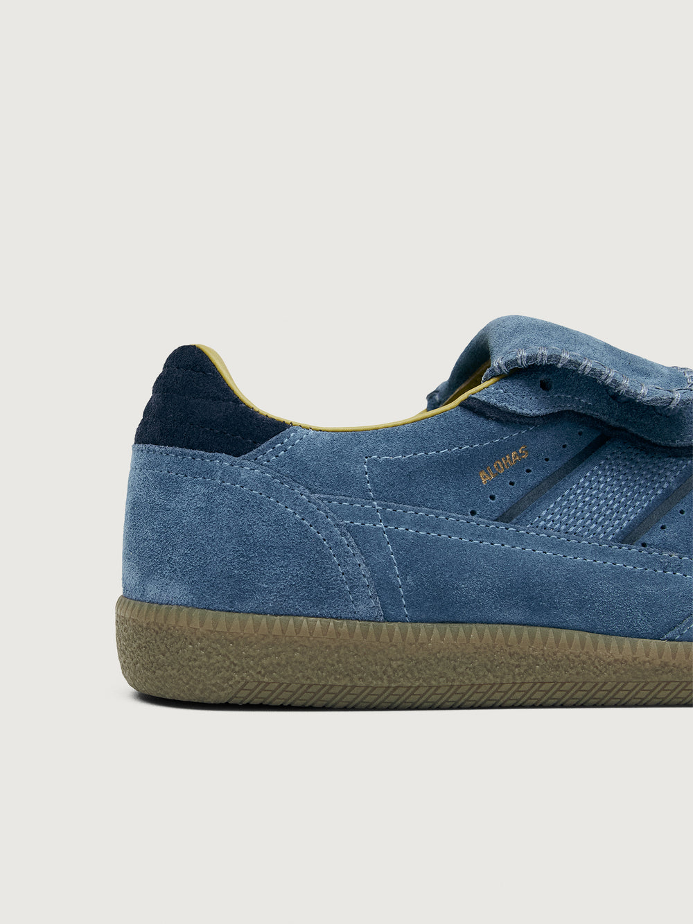 Denim blue suede low top lifestyle sneaker with navy heel detailing. 