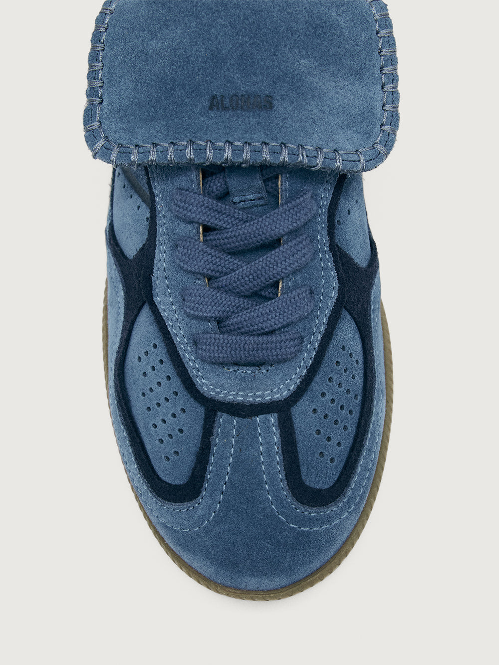 Denim blue suede low top lifestyle sneaker with navy heel detailing. 