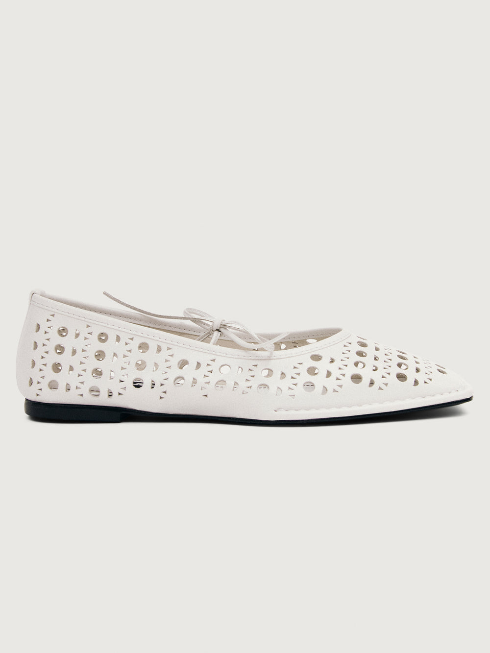 White flat shoe with cut-out design.