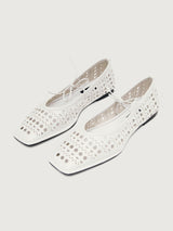White flat shoe with cut-out design.