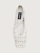 White flat shoe with cut-out design.