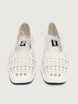 White flat shoe with cut-out design.