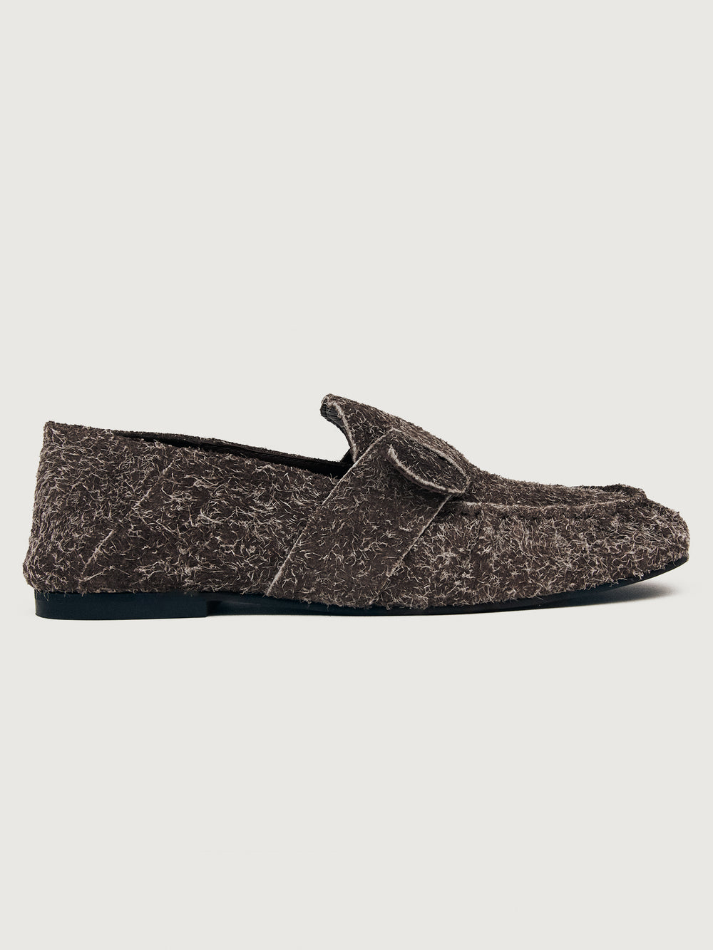 Brown suede loafer shoe.