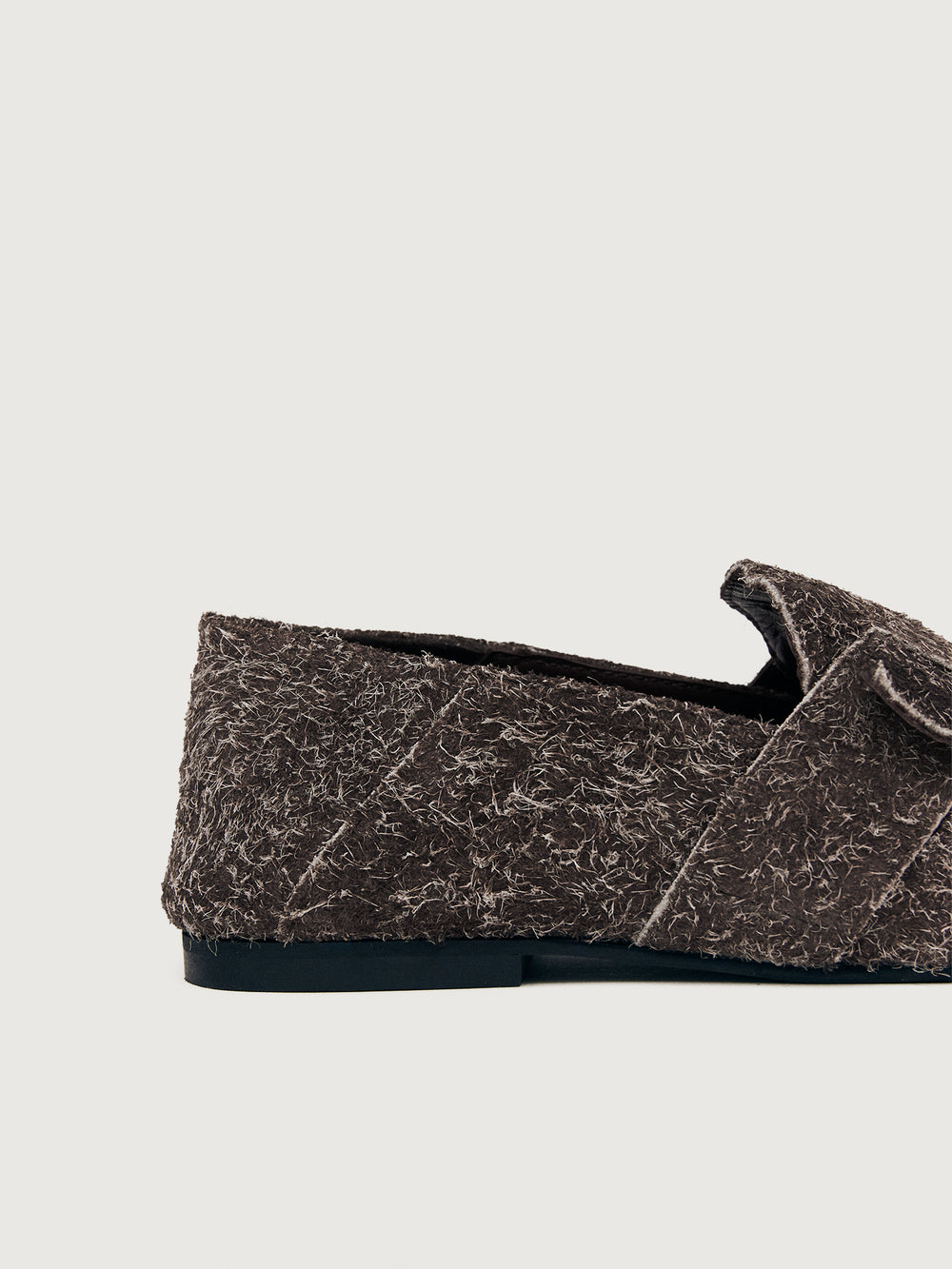 Brown suede loafer shoe.
