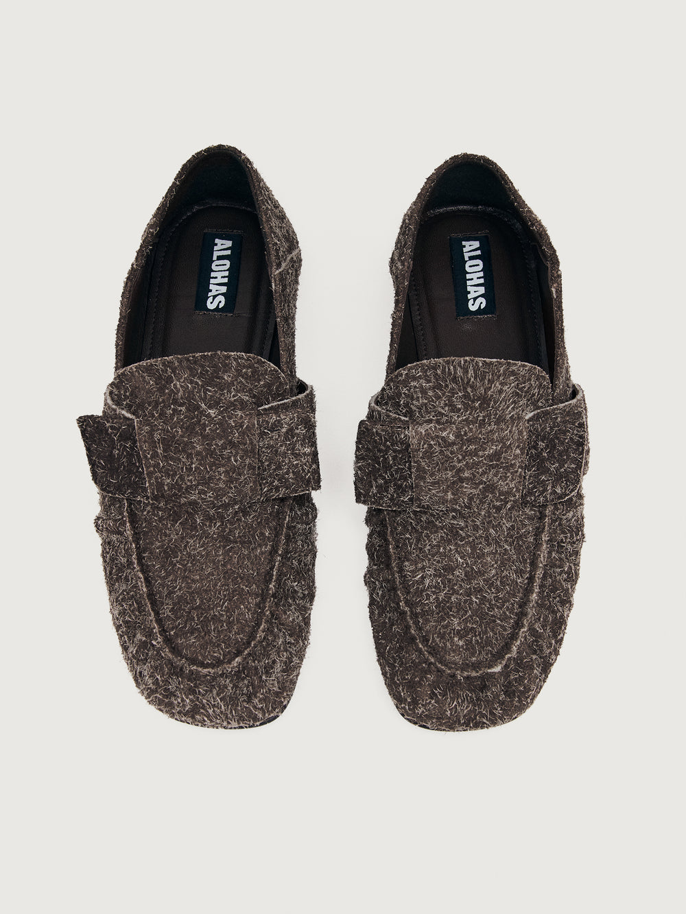 Brown suede loafer shoe.