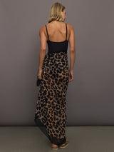 Model wears leopard print skirt with a long, flowy silhouette and a tie closure at the waist.
