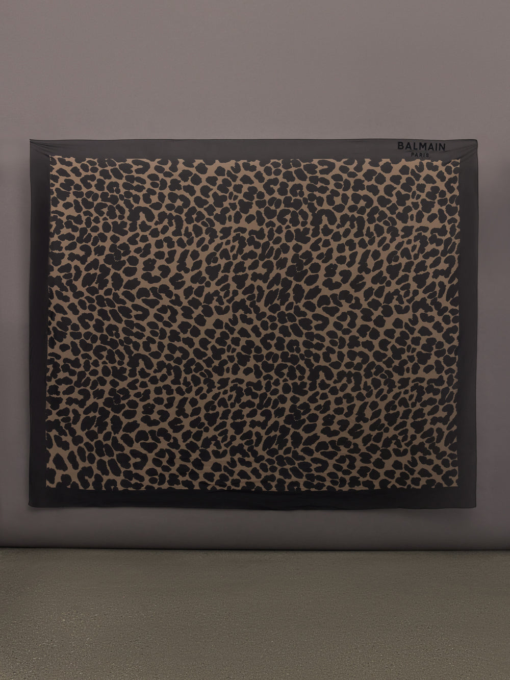 Model wears leopard print skirt with a long, flowy silhouette and a tie closure at the waist.
