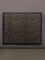 Model wears leopard print skirt with a long, flowy silhouette and a tie closure at the waist.
