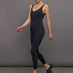 Model wears a black v neck tank full length jumpsuit. 
