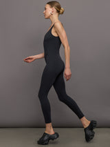 Model wears a black v neck tank full length jumpsuit. 