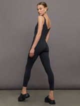 Model wears a black v neck tank full length jumpsuit. 