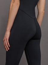 Model wears a black v neck tank full length jumpsuit. 