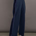 Model wears navy wide leg pants with an elastic waistband. 
