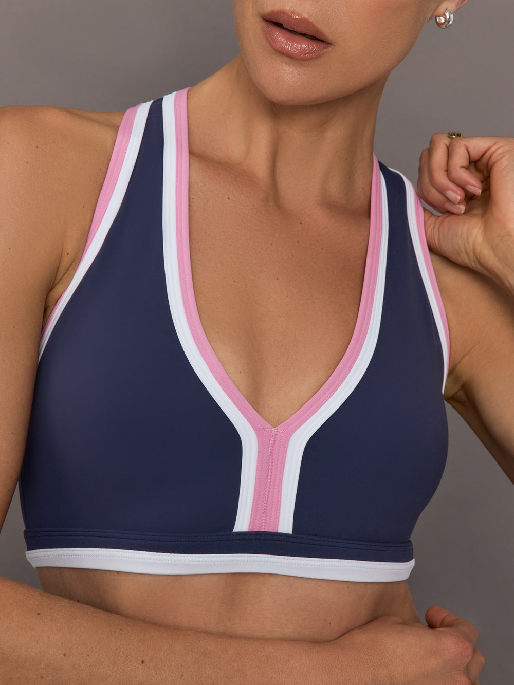 Close-up of Ida Top neckline in navy with pink and white colorblock trim.