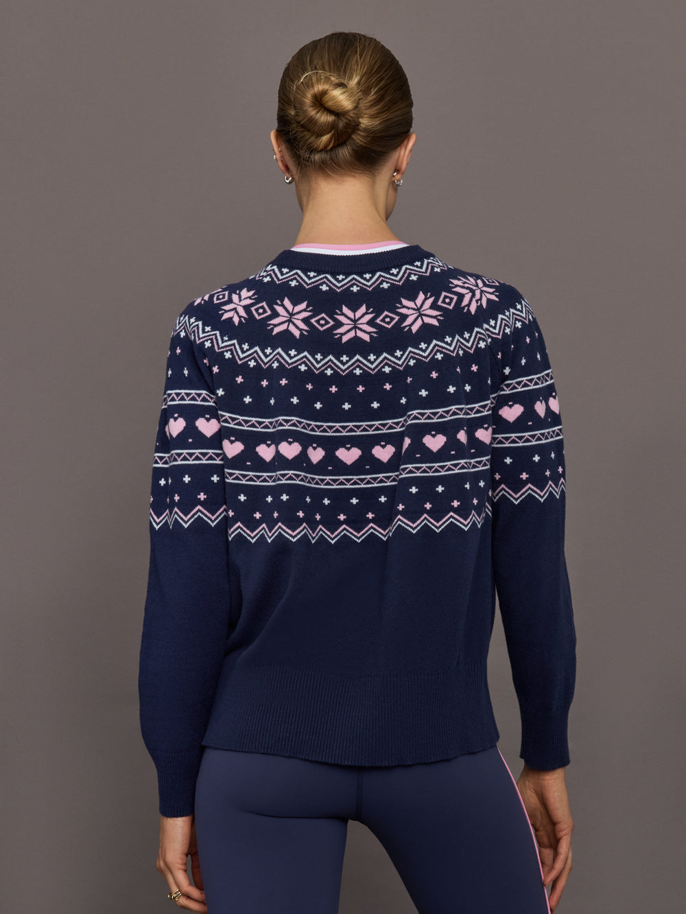 Back view of Fair Isle sweater showing pink heart and snowflake knit design.